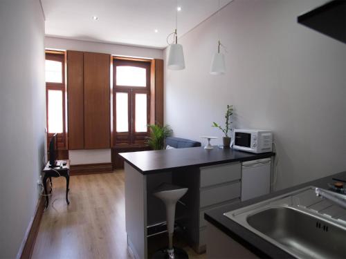 a kitchen with a sink and a counter top at Nidos Accommodation Gaia in Vila Nova de Gaia