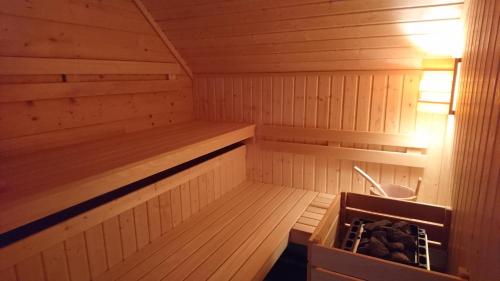 a small wooden sauna with a tub in it at Brunarica Murka in Bohinj
