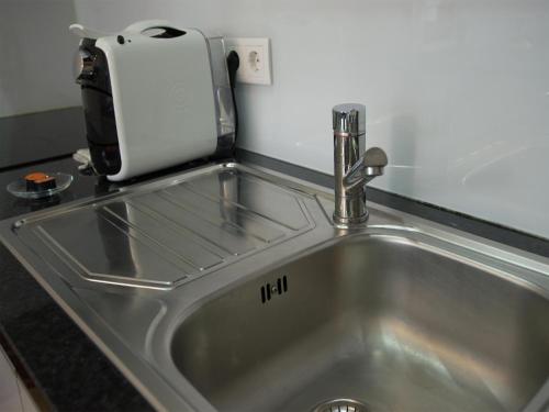 a kitchen sink with a toaster on top of it at Nidos Accommodation Gaia in Vila Nova de Gaia