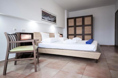 ラス・プラジタスにあるPlayitas Villas - Sports Resortのベッドルーム1室(ベッド1台、椅子付)