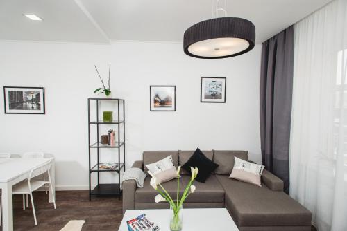 a living room with a couch and a table at Апартаменти біля Оперного Театру in Lviv