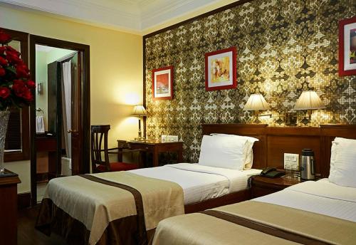 Postel nebo postele na pokoji v ubytování Qutub Residency