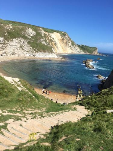 a group of people on a beach near the ocean at Ishara Apartment in Weymouth