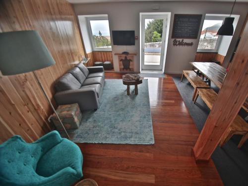a living room with a couch and a table at Manta Ray Lodge in Horta