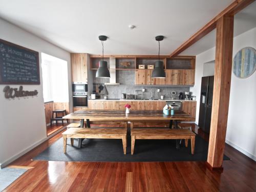 a kitchen with a wooden table in a room at Manta Ray Lodge in Horta