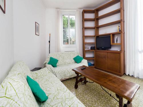 a living room with a couch and a table at Dante Flexyrent Apartment in Rapallo
