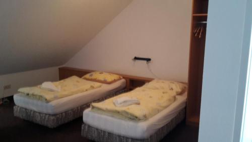 two twin beds in a room with a attic at K & R Appartements Binz in Binz