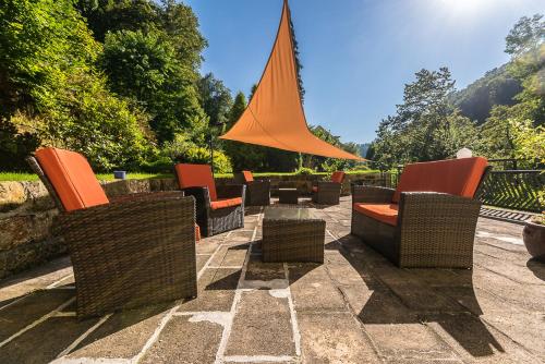 a group of chairs and tables on a patio at Pension Menge in Bad Schandau