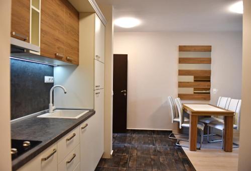 a kitchen and dining room with a table and chairs at Apartments Lucky Complex Ravda in Ravda