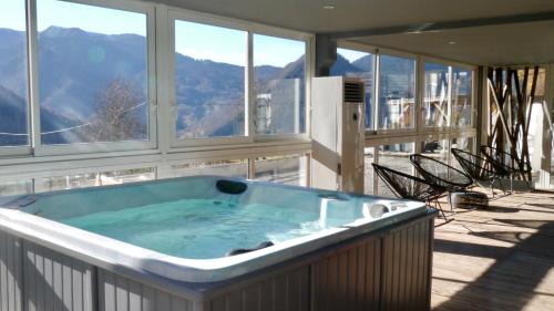 a jacuzzi tub on the balcony of a house at Le Solayan in Couledoux
