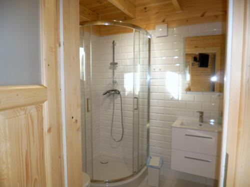 a bathroom with a shower and a sink at Cztery Pory Roku in Trzęsacz