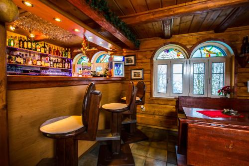 a bar with chairs and a counter in a room at Chata Pod lipami in Rokytnice nad Jizerou