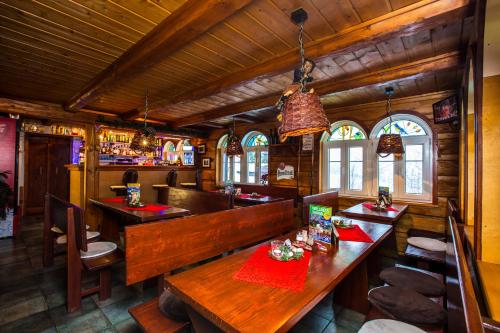 a restaurant with tables and chairs and a bar at Chata Pod lipami in Rokytnice nad Jizerou