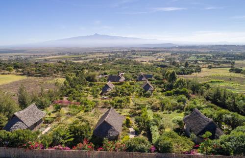 an aerial view of a village with mountains in the background at Rhino Watch Safarilodge in Mweiga