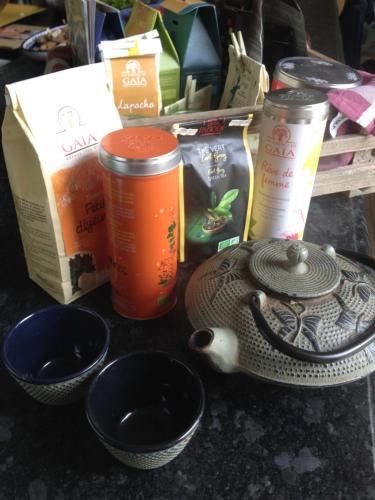 a table with bowls and a tea pot and other items at La Roseraie in Tournai