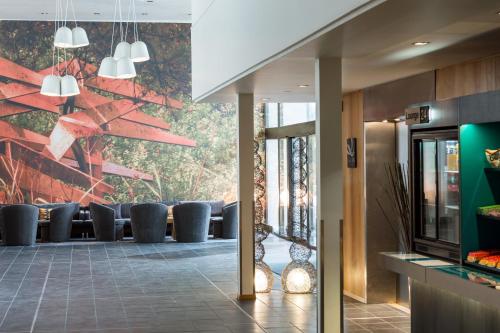 a lobby with couches and a wall of windows at Quality Hotel Entry in Kolbotn