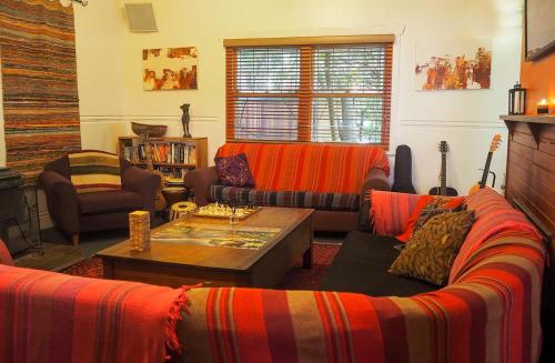 a living room with two couches and a coffee table at Flying Fox Backpackers in Katoomba