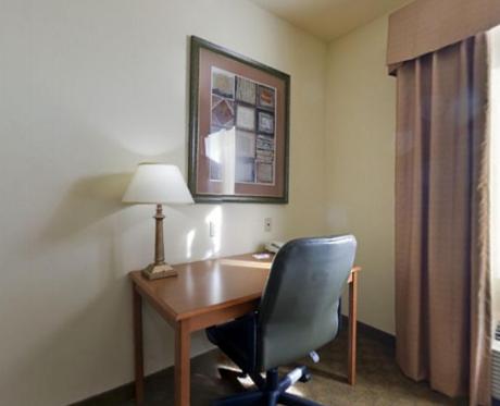 a room with a desk with a chair and a lamp at Holiday Inn Express Hotel & Suites Zapata by IHG in Zapata