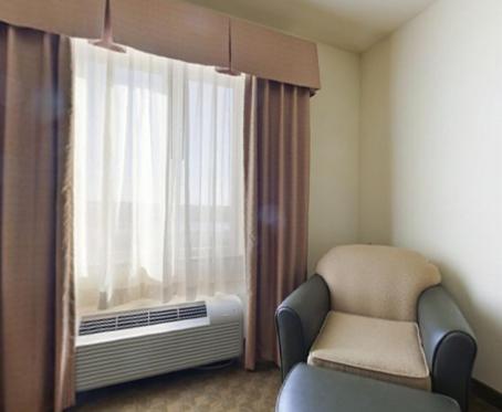 a hospital room with a chair and a window at Holiday Inn Express Hotel & Suites Zapata by IHG in Zapata