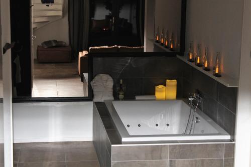 a bathroom with a bath tub in a room at Byonz in Groningen