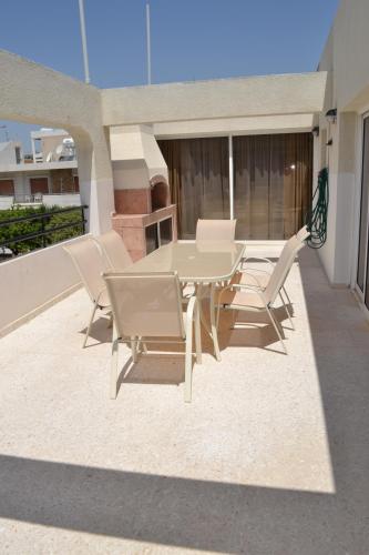 a patio with a table and chairs on a balcony at Marianna Hotel Apartments in Limassol