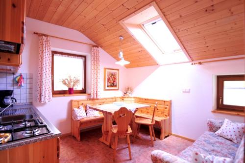 a kitchen with a wooden table in a room at Planatscherhof in Barbiano