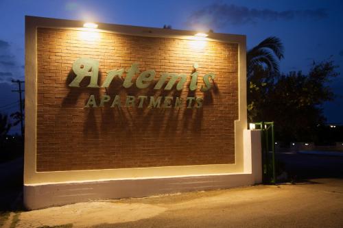 a sign on a brick wall with the words abnormal applications at Artemis Village Apartments & Studios in Stavros