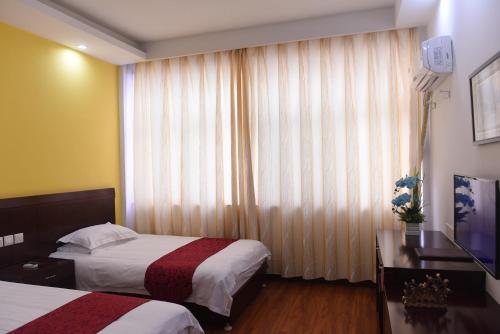 Huangshan Tangkou Haoshi International Youth Hostelにあるベッド