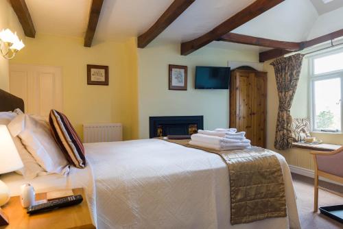 a bedroom with a large bed and a fireplace at Willance House Guest House in Richmond