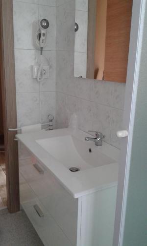 a bathroom with a white sink and a mirror at Appartamento Sophia in Collegno
