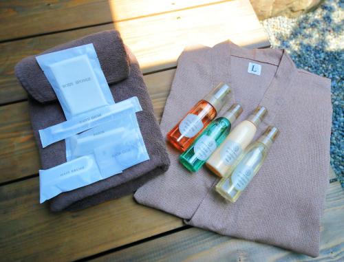 a group of three bottles of liquids sitting on a table at Machiya Oozora in Kyoto