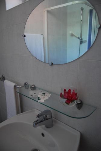 La salle de bains est pourvue d'un lavabo et d'un miroir. dans l'établissement Appartamenti Corneliani II, à Sirmione