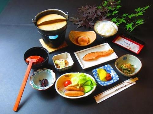 a table topped with bowls of food and chopsticks at Nitaya in Minakami
