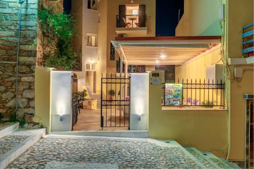 an entrance to a building with a gate at Ethrion in Ermoupoli