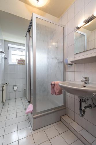 a bathroom with a shower and a sink at Ferienhaus Zunftstuben in Norderney