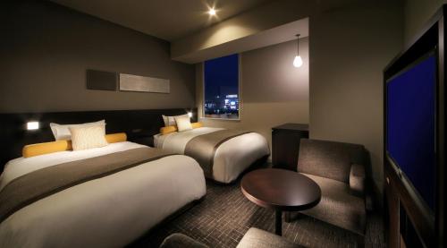 Posteľ alebo postele v izbe v ubytovaní Sendai Washington Hotel