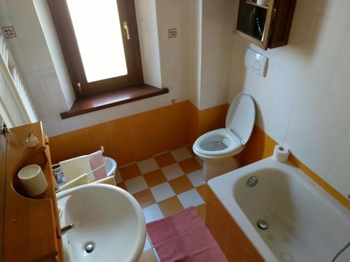 a bathroom with a toilet and a sink and a tub at Podere Pancoli in Massa Marittima