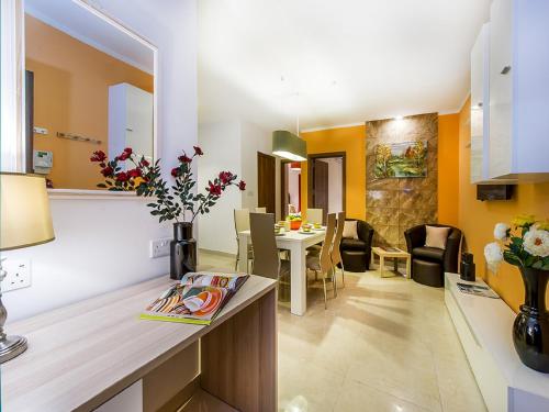 a kitchen and living room with a table and chairs at Bayside Apartments in St Julian's