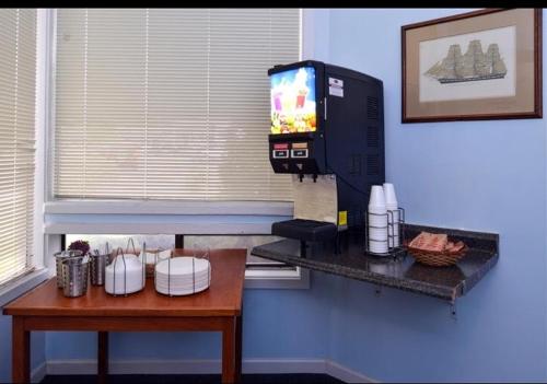 a kitchen counter with a cup of coffee and a microwave at Americas Best Value Inn - Carson City in Carson City