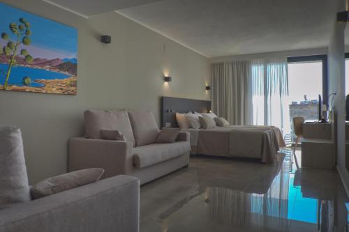 a living room with a bed and a couch at Dos Playas - 30º hotels in Puerto de Mazarrón