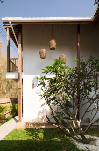 a house with baskets hanging from the side of it at Foresta Villa in Hang Dong