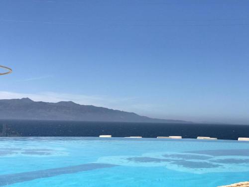 a large swimming pool with a view of the ocean at Sunny Bay Apartments in Sarandë