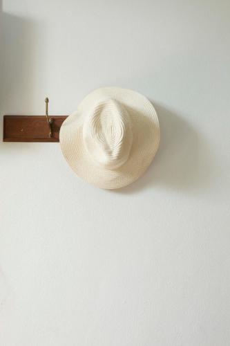 a straw hat is hanging on a wall at Foresta Villa in Hang Dong