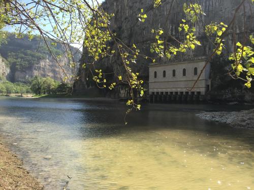 a building sitting in the middle of a river at B&B Corte Barbieri in Dolcè