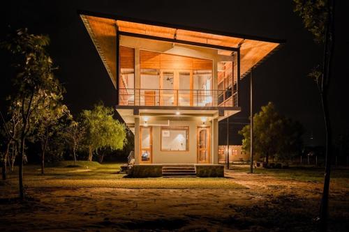 a house is lit up at night at Tree Tops Yala in Yala