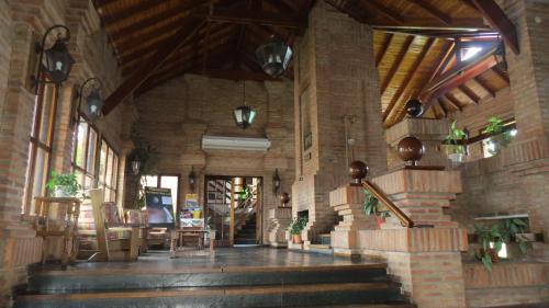 a lobby of a building with a table and chairs at Villa de Merlo All Inclusive & Spa by MH in Merlo