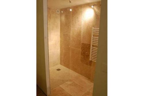 a bathroom with a shower with a glass door at Bastide Provençale Les Mûriers d'Engaspaty in Seillans