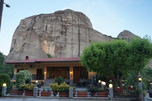 a building in front of a mountain at Guesthouse Papastathis in Kalabaka