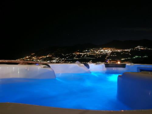 a pool with blue lights at night at Villa Anna in Maiori