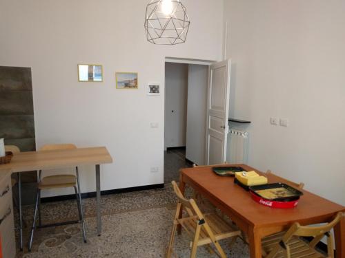 a kitchen with a table and a table and chairs at B&B Al Fronte del Porto in Genova